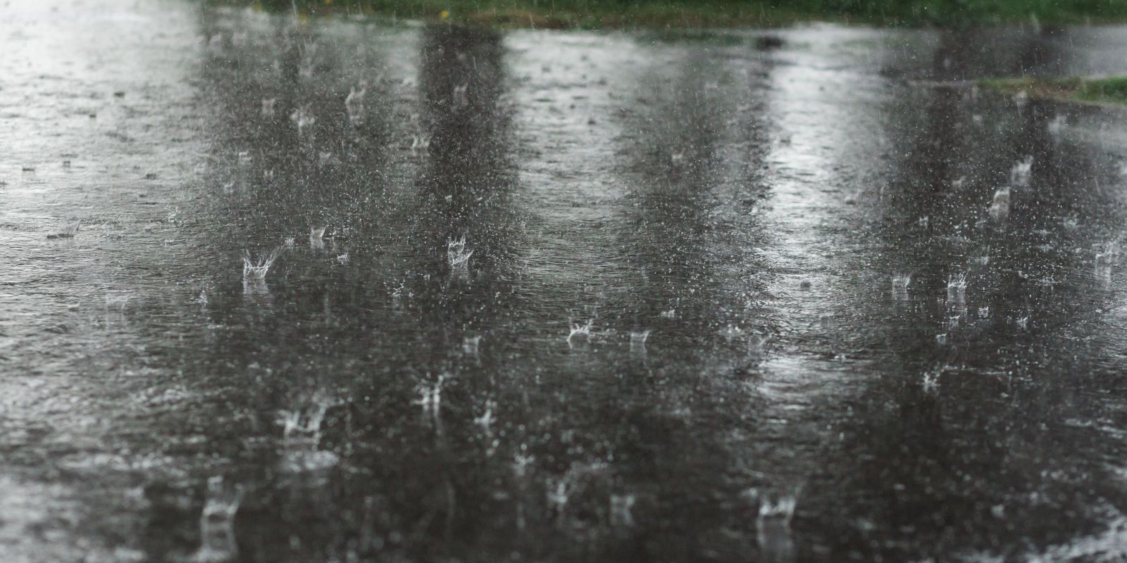 Raindrops falling onto cement.