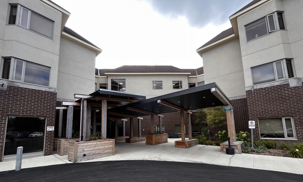 two story brick and stucco building with covered front entrance