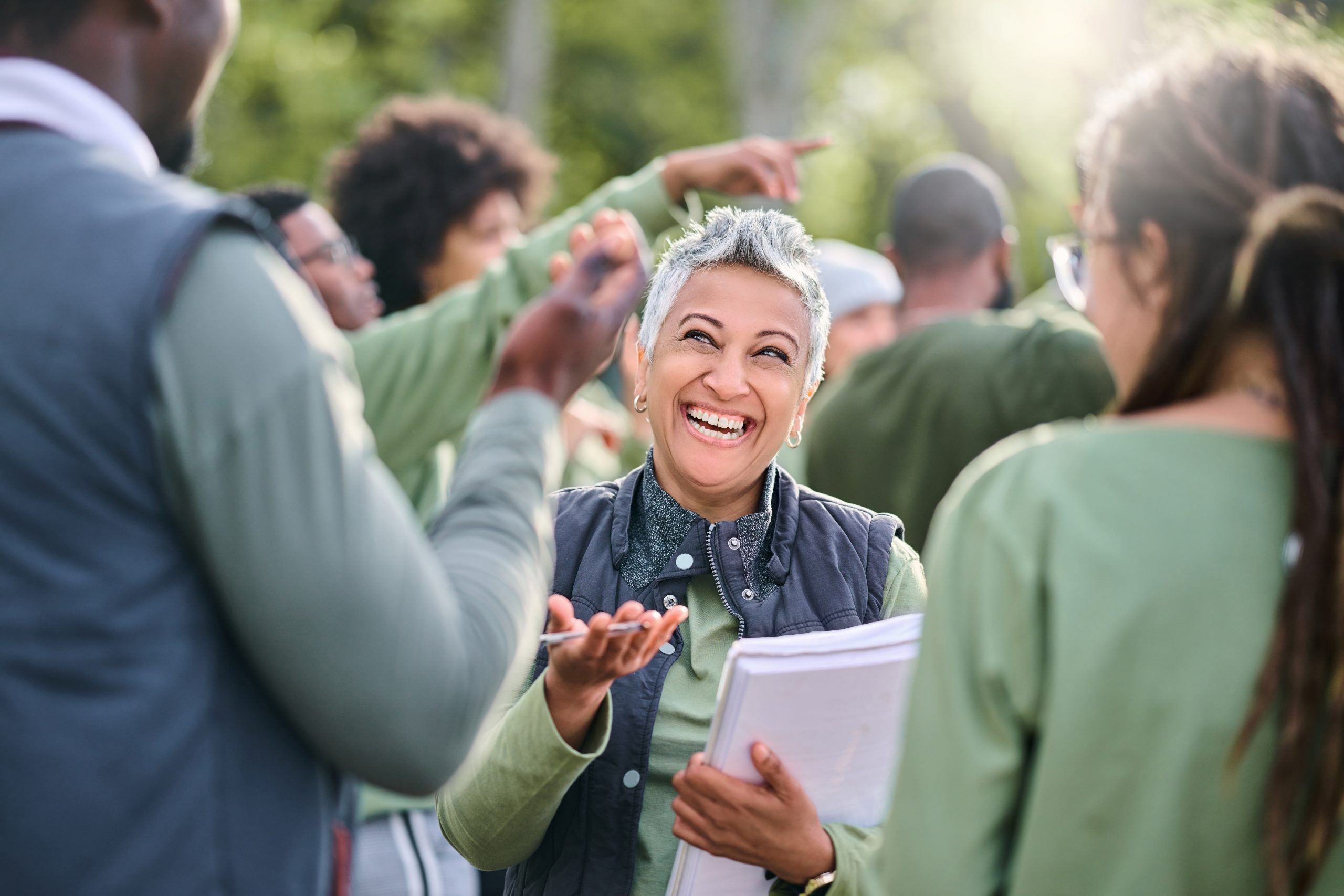 A volunteer speaks with attendees at an event