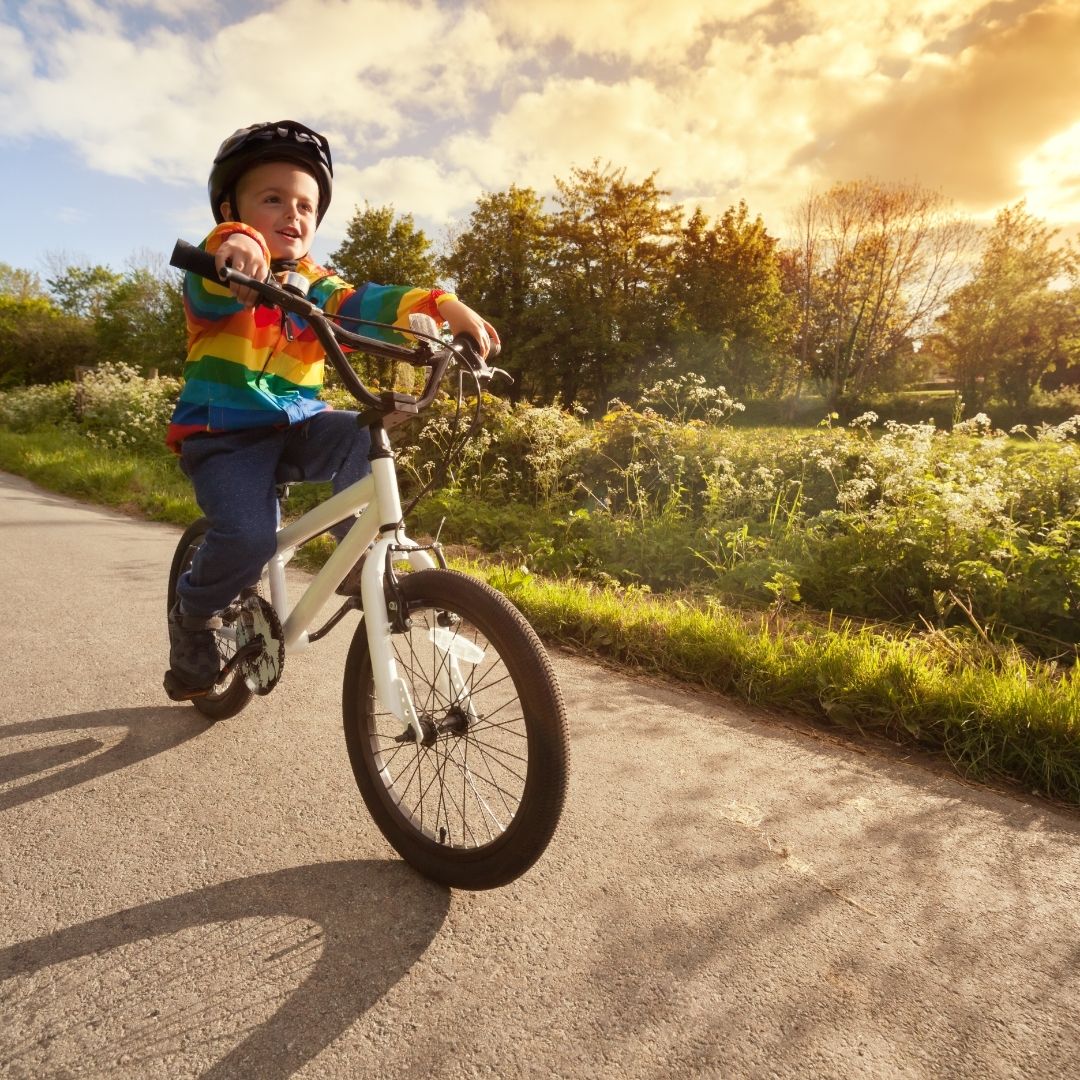 A child rides his bike on a path
