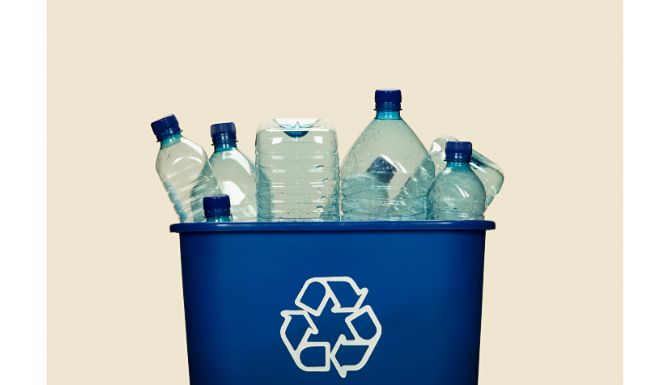 recycling box filled with clear plastic bottles