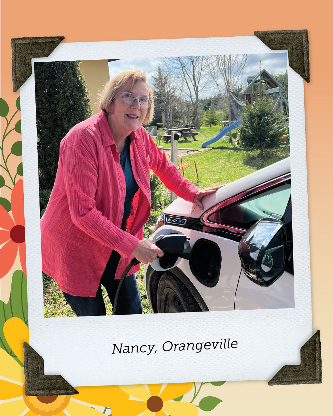 Nancy from Orangeville, wearing a pink shirt and glasses plugs in her electric car at an ecovillage.
