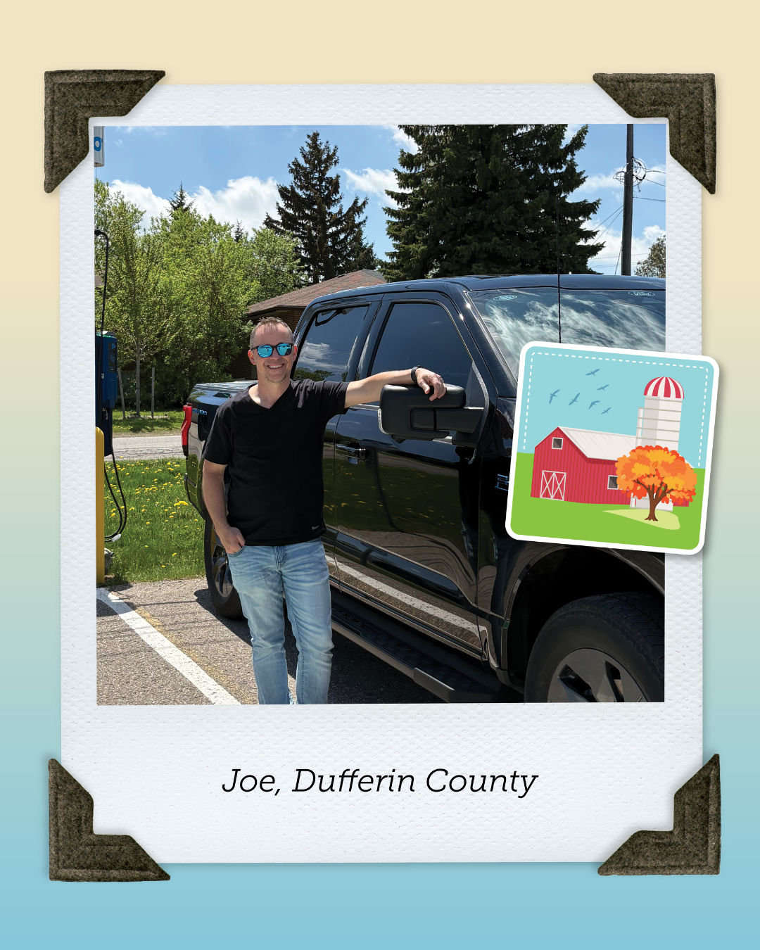 Joe from Dufferin County, wearing a black t-shirt and jeans poses with his electric F150 truck.
