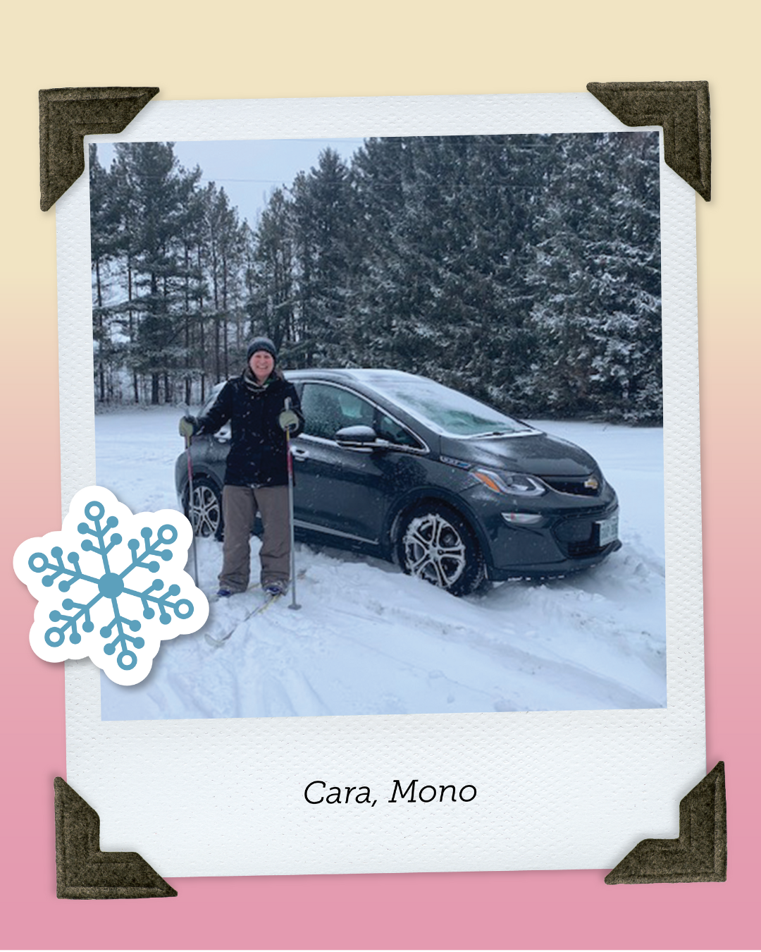 Cara, from Mono, poses in front of electric car on snowy backroads wearing cross country skis.