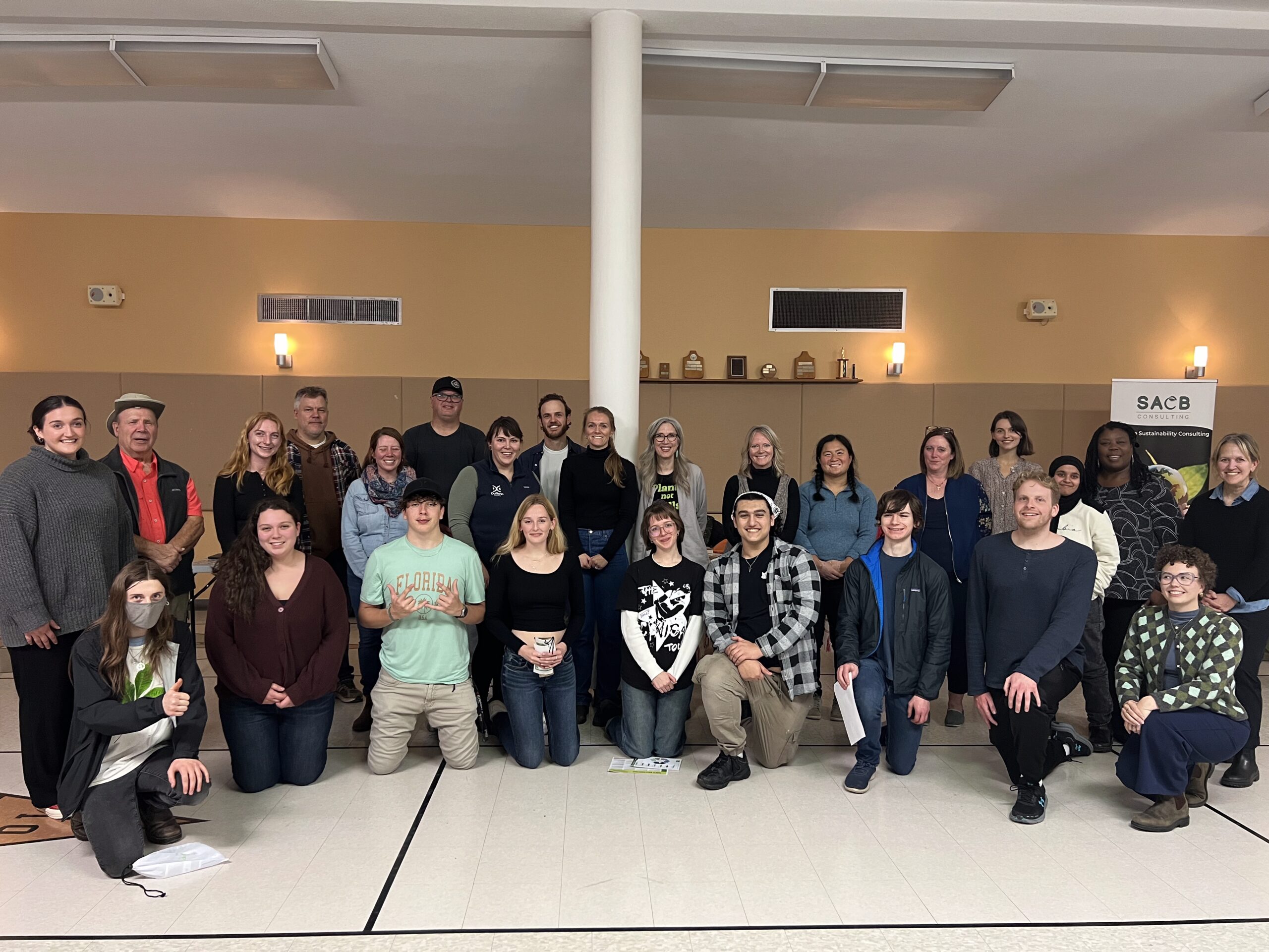 A large group of youth climate ambassadors and community organization staff pose for a group photo at the Climate Solutions Fair event