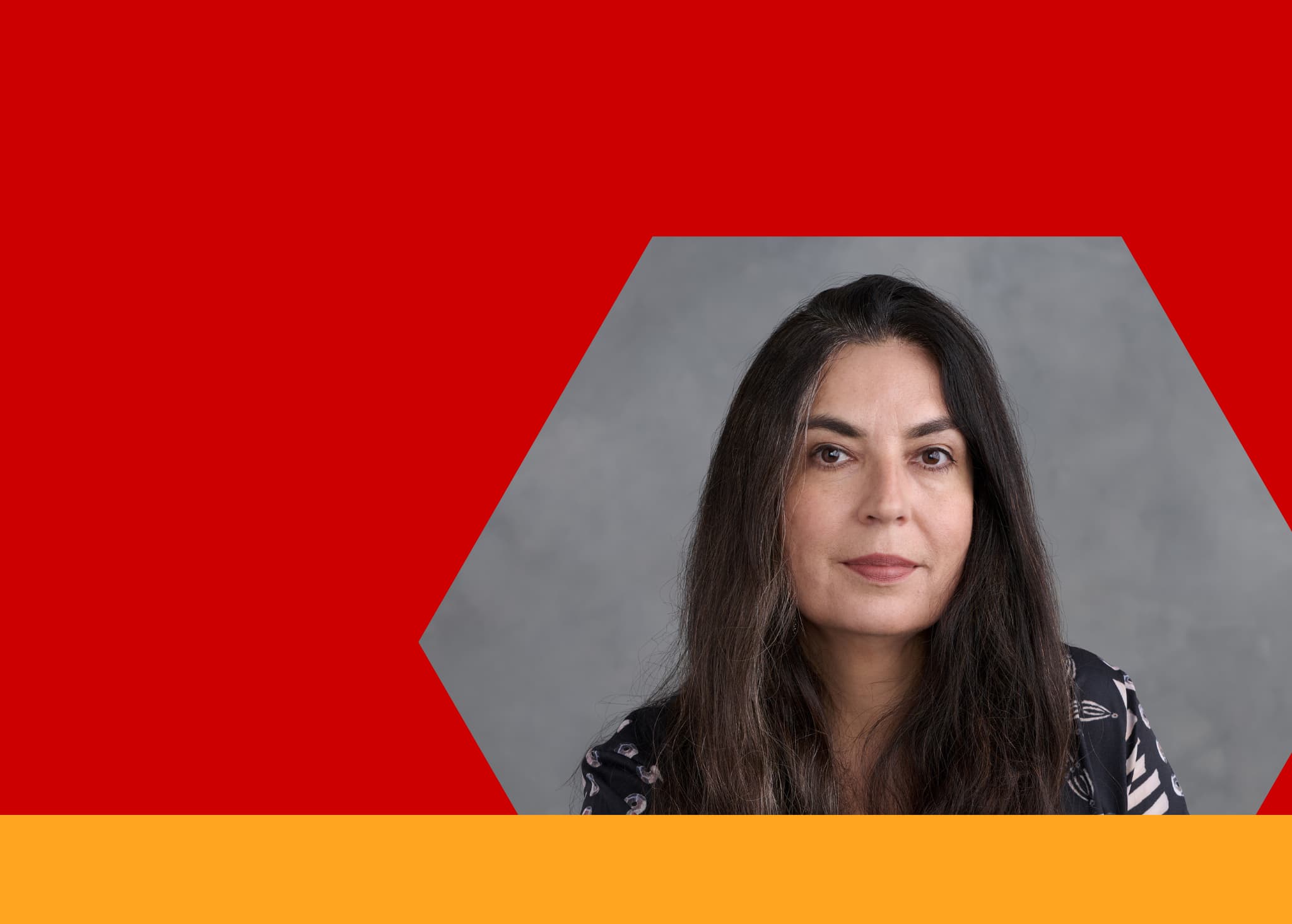 Photo of smiling indigenous woman with red background.