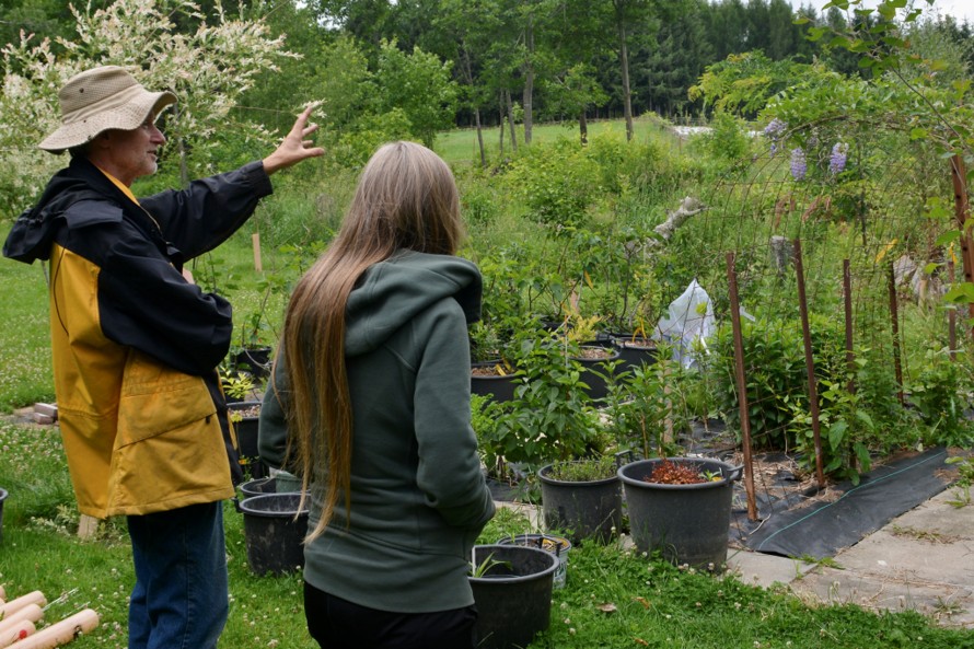 two people talking while on a farm